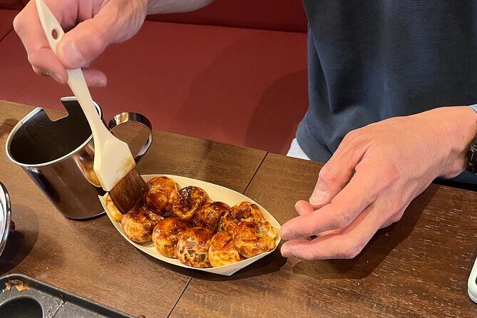 Experience Cooking Takoyaki in its Birthplace, Osaka - Eating the results: toothpicks, hot bites, and an Osaka-style snack party