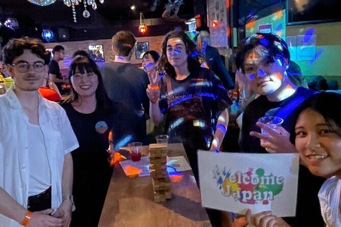 Meet Locals experience Fun Chat Drink Osaka International Party - Check-in setup: wristband and table signs that remove the guesswork
